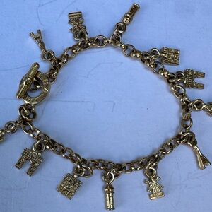 Agatha Paris Charm Bracelet, featuring gold-plated charms Parisian landmarks.